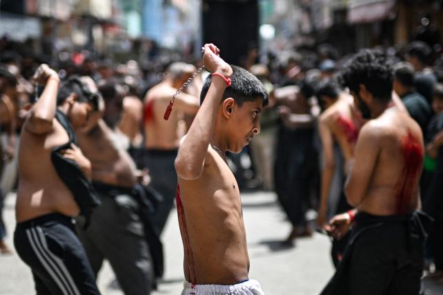 Shiite Muslims flagellate themselves during a religious procession marking Ashura, the tenth day of the Islamic holy month of Muharram, in Chennai on July 6, 2025. (Photo by R.Satish BABU / AFP)