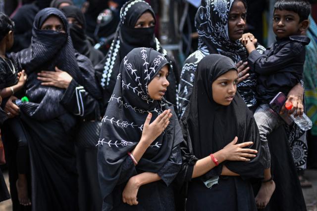 Shiite Muslim women mourn as they watch a religious procession marking Ashura, the tenth day of the Islamic holy month of Muharram, in Chennai on July 6, 2025. (Photo by R.Satish BABU / AFP)