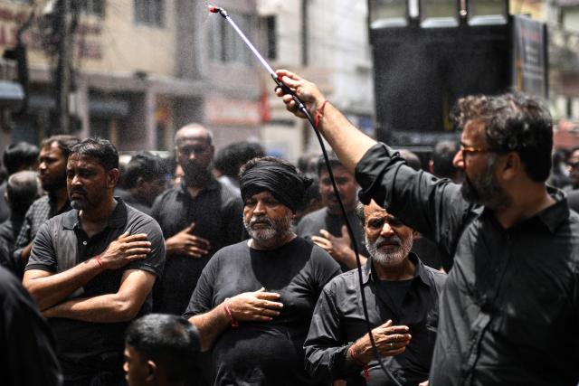People spray rose-water as Shiite Muslims flagellate themselves during a religious procession marking Ashura, the tenth day of the Islamic holy month of Muharram, in Chennai on July 6, 2025. (Photo by R.Satish BABU / AFP)