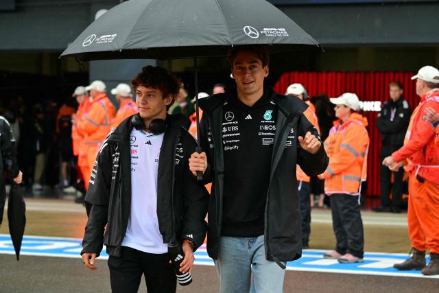 Mercedes' Italian driver Kimi Antonelli (L) and Mercedes' British driver George Russell (R) head out for the drivers' parade ahead of the Formula One British Grand Prix at the Silverstone motor racing circuit in Silverstone, central England, on July 6, 2025. (Photo by Andrej ISAKOVIC / AFP)