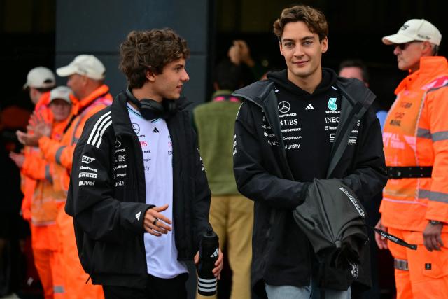 Mercedes' Italian driver Kimi Antonelli (L) and Mercedes' British driver George Russell (R) head out for the drivers' parade ahead of the Formula One British Grand Prix at the Silverstone motor racing circuit in Silverstone, central England, on July 6, 2025. (Photo by Andrej ISAKOVIC / AFP)
