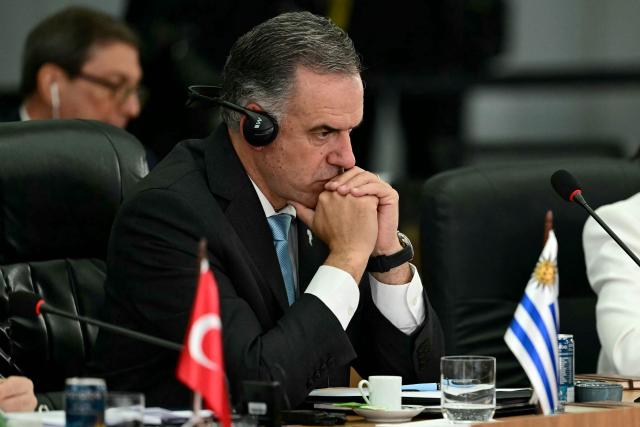 Uruguay's President Yamandu Orsi gestures during the BRICS summit second plenary session in Rio de Janeiro, Brazil, on July 6, 2025. BRICS leaders descended on sunny Rio de Janeiro, but issued a dark warning that US President Donald Trump's "indiscriminate" import tariffs risk hurting the global economy, warning they are illegal and arbitrary, according to a final summit statement. (Photo by Pablo PORCIUNCULA / AFP)