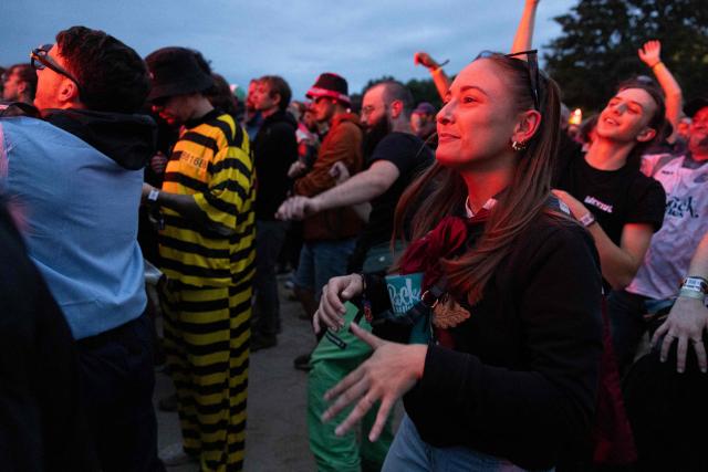A festival goer dances as French DJ 'I Hate Models' performs on stage during the 35th edition of the "Eurockeennes de Belfort" music festival in Sermamagny, eastern France, on July 6, 2025. (Photo by ROMEO BOETZLE / AFP)
