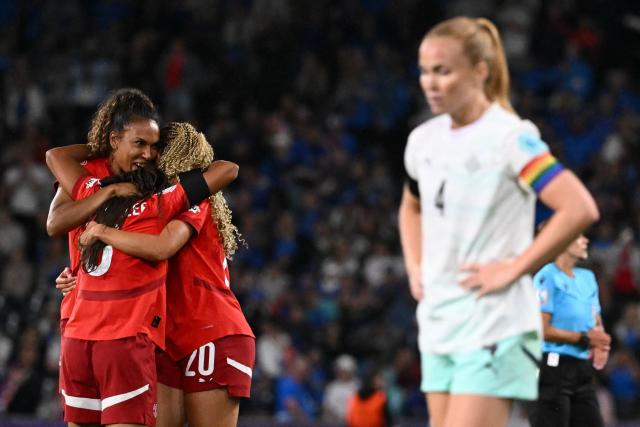 Switzerland's forward #20 Alayah Pilgrim celebrates with teammates after scoring the second goal of the match as Iceland's defender #04 Glodis Viggosdottir walks away, during the UEFA Women's Euro 2025 Group A football match between Switzerland and Iceland at the Wankdorf stadium in Bern, on July 6, 2025. (Photo by SEBASTIEN BOZON / AFP)