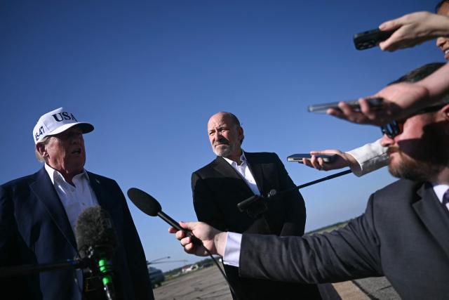 (L/R) US President Donald Trump and Secretary of Commerce Howard Lutnick speak to reporters before boarding Air Force One at Morristown Municipal Airport in Morristown, New Jersey, on July 6, 2025, en route to Washington after spending the weekend at his residence in Bedminster, New Jersey. (Photo by Brendan SMIALOWSKI / AFP)