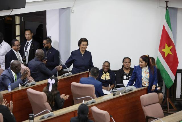 Suriname's opposition leader Jennifer Geerlings-Simons (C) greets parliamentarians after the National Assembly election in Paramaribo on July 6, 2025. Lawmakers elected Jennifer Geerlings-Simons as Suriname's first woman president on July 6, 2025, after her party won the most seats in legislative elections in May. (Photo by Ranu Abhelakh / AFP)