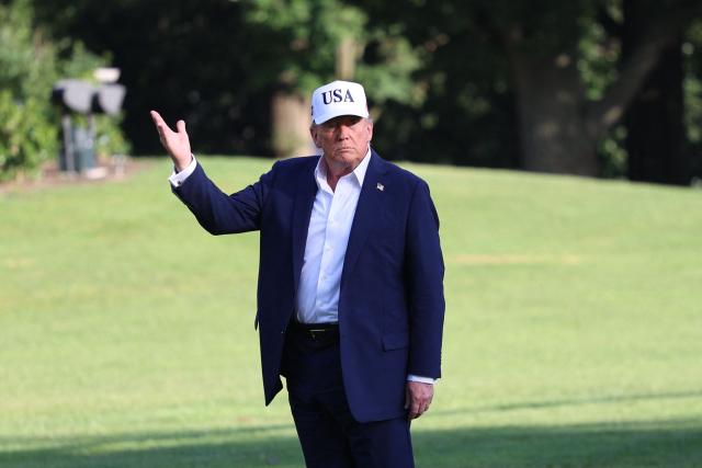 US President Donald Trump stops to gesture at the US flag as he walks on the South Lawn from Marine One to the White House in Washington, DC on July 6, 2025, after spending the weekend at his residence in Bedminster, New Jersey. (Photo by Alex WROBLEWSKI / AFP)