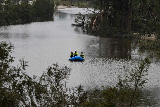 Members of a rescue team look for missing people on the Guadalupe River in Kerrville, Texas, on July 6, 2025, following severe flash flooding that occured during the July 4 holiday weekend. Rescuers in Texas raced against time Sunday to find dozens of missing people, including children, swept away by flash floods that killed at least 78, as forecasters warned of new deluges. Local Texans joined forces with disaster officials to search through the night for the missing, including 27 girls from a riverside Christian summer camp. Texas Governor Greg Abbott said Camp Mystic on the banks of the Guadalupe River, where some 750 girls had been staying when the floodwaters hit, had been "horrendously ravaged in ways unlike I've seen in any natural disaster." (Photo by RONALDO SCHEMIDT / AFP)