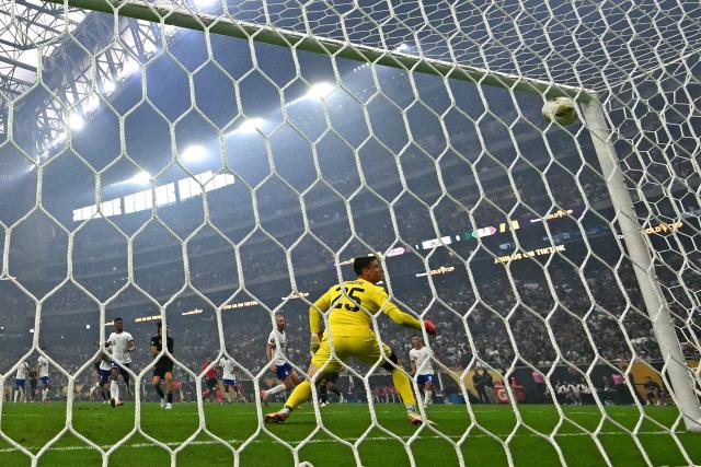 Mexico's forward #09 Raul Jimenez (L) celebrates scoring his team's first goal as United States' goalkeeper #25 Matt Freese eyes the ball during the Concacaf Gold Cup final football match between Mexico and USA at NRG Stadium in Houston, Texas on July 6, 2025. (Photo by Chandan Khanna / AFP)