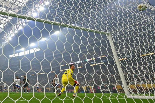 Mexico's forward #09 Raul Jimenez (L) celebrates scoring his team's first goal as United States' goalkeeper #25 Matt Freese eyes the ball during the Concacaf Gold Cup final football match between Mexico and USA at NRG Stadium in Houston, Texas on July 6, 2025. (Photo by Chandan Khanna / AFP)