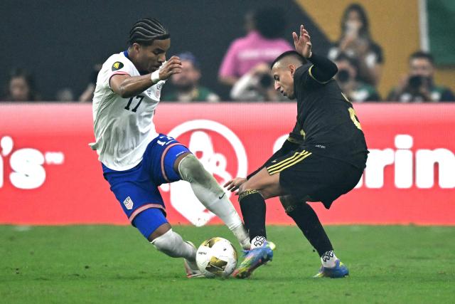 United States' midfielder #17 Malik Tillman fights for the ball with Mexico's midfielder #25 Roberto Alvarado during the Concacaf Gold Cup final football match between Mexico and USA at NRG Stadium in Houston, Texas on July 6, 2025. (Photo by CHANDAN KHANNA / AFP)