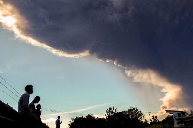 Villagers observe Mount Lewotobi Laki-laki as it erupts, as seen from Nangahale village in Sikka, East Nusa Tenggara on July 7, 2025. (Photo by ARNOLD WELIANTO / AFP)