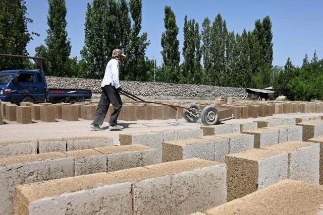 A view of the production facility of rice construction blocks, made mostly of rice husks - a byproduct of rice processing, in the Batken region in southern Kyrgyzstan on May 22, 2025. (Photo by Guliza Urustambek kyzy / AFP)