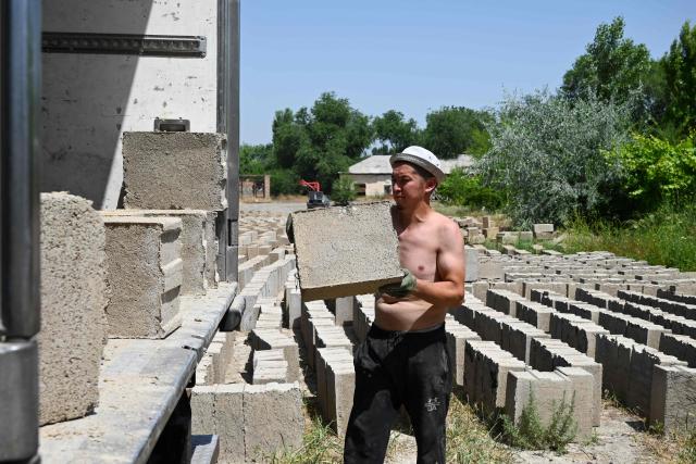 A view of the production facility of rice construction blocks, made mostly of rice husks - a byproduct of rice processing, in the Batken region in southern Kyrgyzstan on May 22, 2025. (Photo by Guliza Urustambek kyzy / AFP)