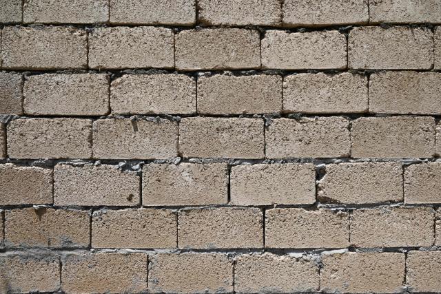 Workers build a house with rice construction blocks, made mostly of rice husks - a byproduct of rice processing, in the Kyzyl-Kiya village in southern Kyrgyzstan on May 22, 2025. (Photo by Guliza Urustambek kyzy / AFP)