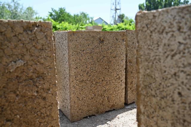 A view of the production facility of rice construction blocks, made mostly of rice husks - a byproduct of rice processing, in the Batken region in southern Kyrgyzstan on May 22, 2025. (Photo by Guliza Urustambek kyzy / AFP)
