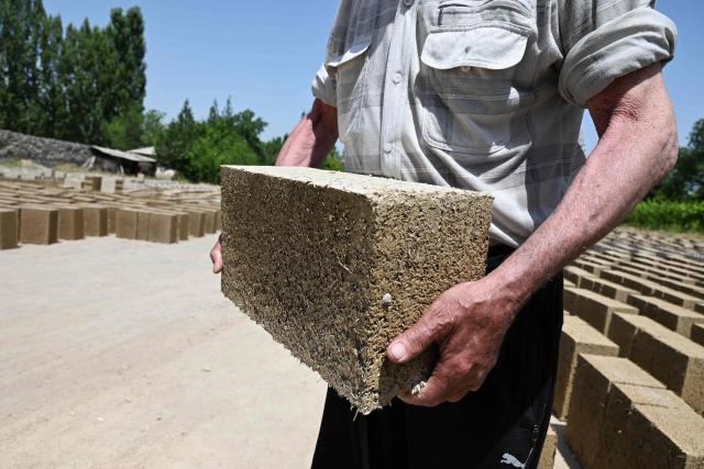 A view of the production facility of rice construction blocks, made mostly of rice husks - a byproduct of rice processing, in the Batken region in southern Kyrgyzstan on May 22, 2025. (Photo by Guliza Urustambek kyzy / AFP)