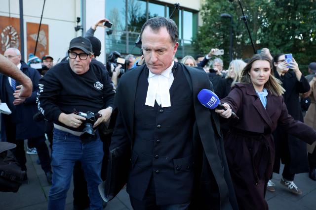 Lead barrister Colin Mandy (C) is surrounded by members of the media as he leaves the Latrobe Valley Magistrates' Court in Morwell on July 7, 2025. An Australian woman murdered her husband's parents and aunt by lacing their beef Wellington lunch with toxic mushrooms, a jury found on July 7 at the climax of a trial watched around the world. Keen home cook Erin Patterson hosted an intimate meal in July 2023 that started with good-natured banter and earnest prayer -- but ended with three guests dead. (Photo by MARTIN KEEP / AFP)