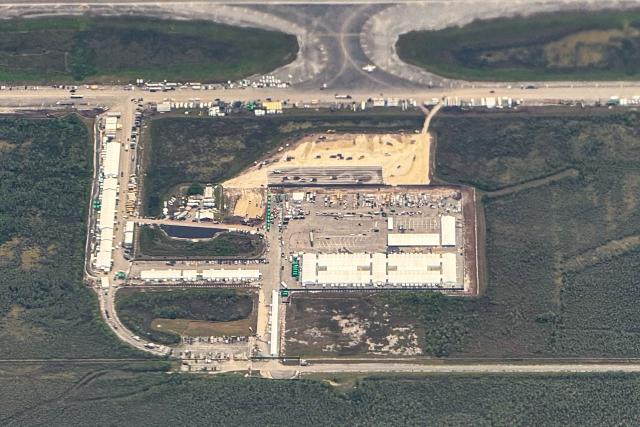 An ariel view of a migrant detention center, dubbed "Alligator Alcatraz," is seen located at the site of the Dade-Collier Training and Transition Airport in Ochopee, Florida on July 7, 2025. The $450 million camp has been built on a disused airfield deep in the Florida Everglades and is surrounded by swamps that are home to creatures including alligators and poisonous snakes. The steaming hot, mosquito-infested site is a symbol of the Republican administration's determination to look tough as it pursues its policy of mass deportations of undocumented migrants. (Photo by CHANDAN KHANNA / AFP)