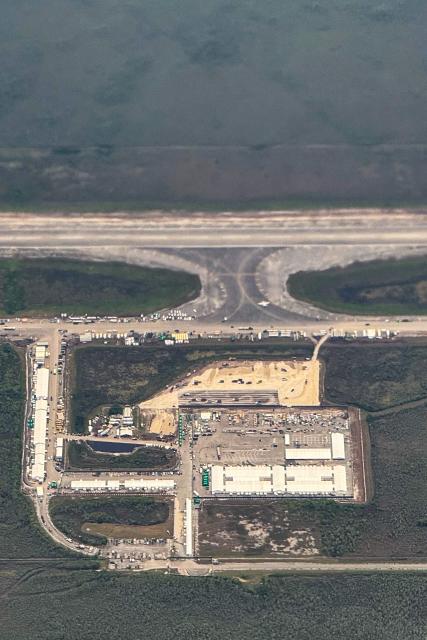 An ariel view of a migrant detention center, dubbed "Alligator Alcatraz," is seen located at the site of the Dade-Collier Training and Transition Airport in Ochopee, Florida on July 7, 2025. The $450 million camp has been built on a disused airfield deep in the Florida Everglades and is surrounded by swamps that are home to creatures including alligators and poisonous snakes. The steaming hot, mosquito-infested site is a symbol of the Republican administration's determination to look tough as it pursues its policy of mass deportations of undocumented migrants. (Photo by CHANDAN KHANNA / AFP)
