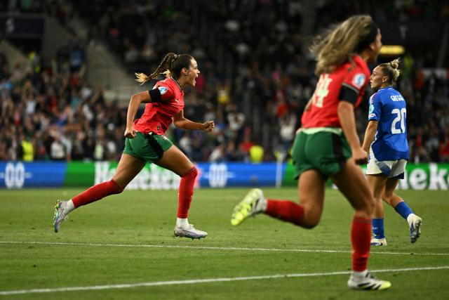 Portugal's defender #19 Diana Gomes (L) celebrates after scoring Portugal's first goal during the UEFA Women's Euro 2025 Group B football match between Portugal and Italy at the Stade de Geneve in Geneva, on July 7, 2025. (Photo by Fabrice COFFRINI / AFP)