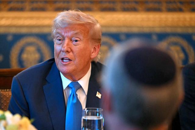 US President Donald Trump meets with unseen Israeli Prime Minister Benjamin Netanyahu at the Blue Room of the White House in Washington, DC, on July 7, 2025. Prime Minister Netanyahu will meet Monday with President Trump, who expressed hope for a "deal this week" between Israel and Hamas that sees hostages released from the Gaza Strip. Indirect negotiations between Israel and Hamas began on July 6 in Doha, aiming to broker a ceasefire and reach an agreement on the release of hostages in exchange for Palestinian prisoners. (Photo by ANDREW CABALLERO-REYNOLDS / AFP)