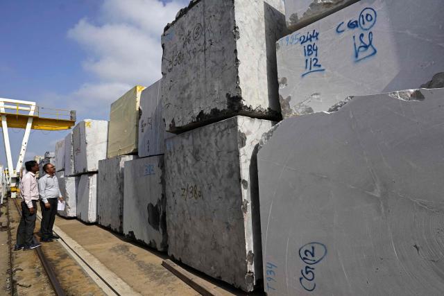 Workers inspect imported stones at a marble factory in Kishangarh, in India's Rajasthan state on July 8, 2025. New Delhi and Washington have been locked in multiple rounds of talks, with hopes for an interim pact to avert the 26 percent "reciprocal" tolls meted out to India. (Photo by HIMANSHU SHARMA / AFP)