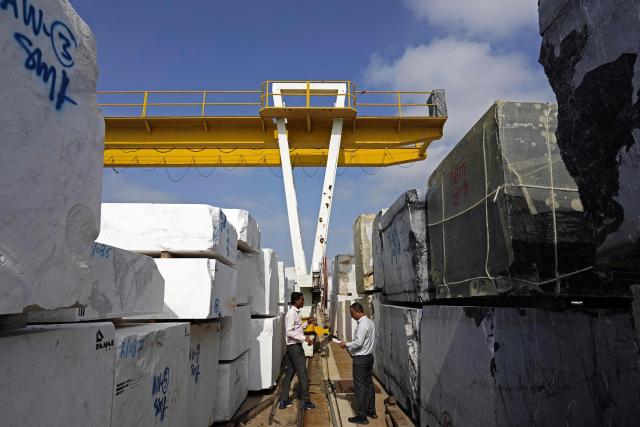 Workers inspect imported stones at a marble factory in Kishangarh, in India's Rajasthan state on July 8, 2025. New Delhi and Washington have been locked in multiple rounds of talks, with hopes for an interim pact to avert the 26 percent "reciprocal" tolls meted out to India. (Photo by HIMANSHU SHARMA / AFP)
