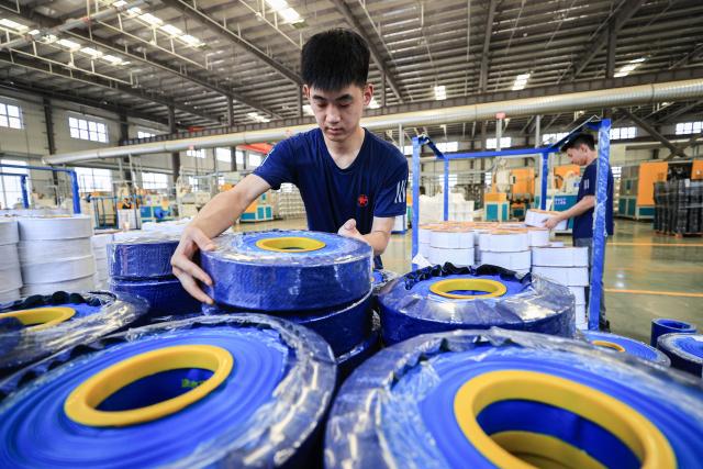 An employee works on a production line of tubular products for export at a factory in Lianyungang, in eastern China's Jiangsu province on July 8, 2025. US President Donald Trump reignited his trade war by threatening more than a dozen countries with higher tariffs on July 7 -- but then said he may be flexible on his new August deadline to reach deals. So far only two firm deals have emerged, with Britain and Vietnam, plus an agreement to dial back super-high tit-for-tat tariffs with China. (Photo by AFP) / China OUT