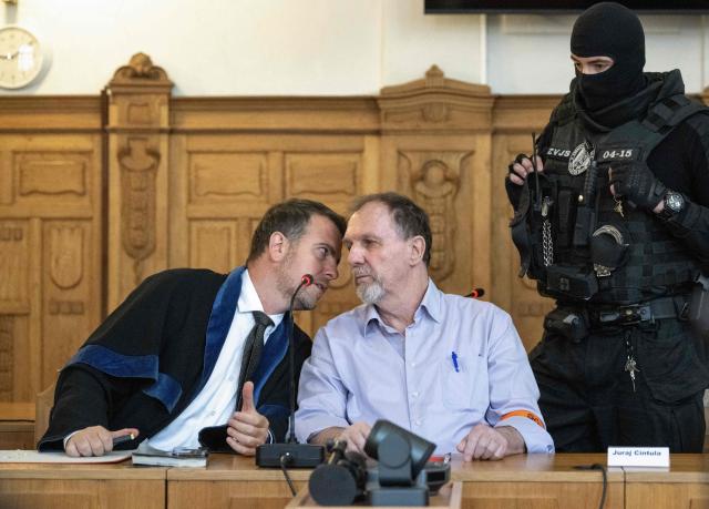 Defendant Juraj Cintula (R), a 72-year-old poet, talks with his lawyer Namir Alyastry (L) in the courtroom in Banska Bystrica, Slovakia, on July 8, 2025, before the start of his trial where he is accused of shooting Slovakia's Prime Minister Robert Fico (unseen) on May 15, 2024. The man who admitted to shooting Slovak Prime Minister Robert Fico is due to stand trial on terror charges on July 7, 2025 in the central Slovak city of Banska Bystrica, more than a year after the attack shocked the central European country. Detained at the scene, Juraj Cintula, a 72-year-old poet, who has admitted to shooting the leader with the intention to wound but not kill him, is facing up to life in prison if convicted. (Photo by Joe Klamar / AFP)