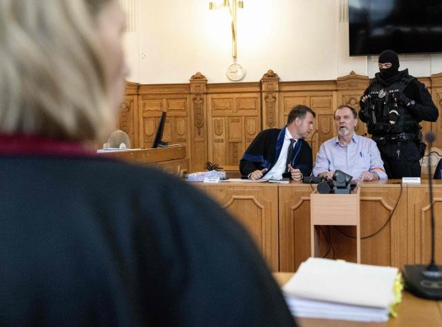 Defendant Juraj Cintula (R), a 72-year-old poet, talks with his lawyer Namir Alyastry (L) in the courtroom in Banska Bystrica, Slovakia, on July 8, 2025, before the start of his trial where he is accused of shooting Slovakia's Prime Minister Robert Fico (unseen) on May 15, 2024. The man who admitted to shooting Slovak Prime Minister Robert Fico is due to stand trial on terror charges on July 7, 2025 in the central Slovak city of Banska Bystrica, more than a year after the attack shocked the central European country. Detained at the scene, Juraj Cintula, a 72-year-old poet, who has admitted to shooting the leader with the intention to wound but not kill him, is facing up to life in prison if convicted. (Photo by Joe Klamar / AFP)
