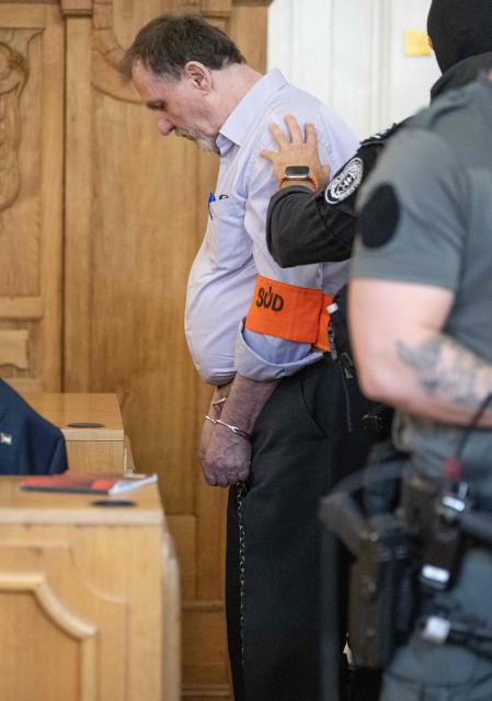 Defendant Juraj Cintula (L), a 72-year-old poet, arrives in the courtroom in Banska Bystrica, Slovakia, on July 8, 2025, before the start of his trial where he is accused of shooting Slovakia's Prime Minister Robert Fico (unseen) on May 15, 2024. The man who admitted to shooting Slovak Prime Minister Robert Fico is due to stand trial on terror charges on July 7, 2025 in the central Slovak city of Banska Bystrica, more than a year after the attack shocked the central European country. Detained at the scene, Juraj Cintula, a 72-year-old poet, who has admitted to shooting the leader with the intention to wound but not kill him, is facing up to life in prison if convicted. (Photo by Joe Klamar / AFP)