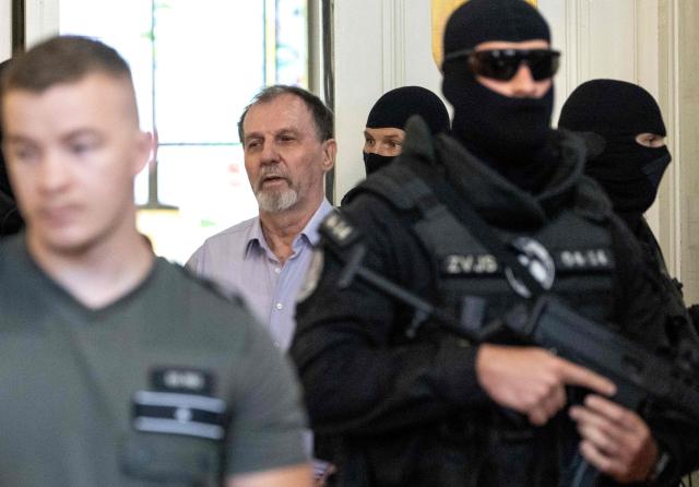Police escort Juraj Cintula (C), a 72-year-old poet, into the courtroom in Banska Bystrica, Slovakia, on July 8, 2025, for the start of his trial where he is accused of shooting Slovakia's Prime Minister Robert Fico (unseen) on May 15, 2024. The man who admitted to shooting Slovak Prime Minister Robert Fico is due to stand trial on terror charges on July 7, 2025 in the central Slovak city of Banska Bystrica, more than a year after the attack shocked the central European country. Detained at the scene, Juraj Cintula, a 72-year-old poet, who has admitted to shooting the leader with the intention to wound but not kill him, is facing up to life in prison if convicted. (Photo by Joe Klamar / AFP)