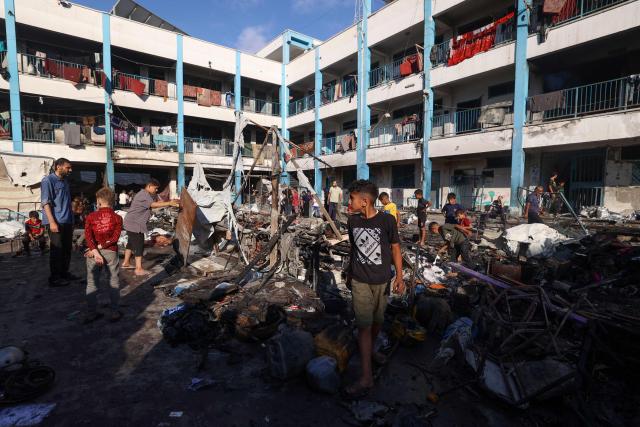 Palestinians check the destruction after an Israeli strike which hit a school sheltering displaced Palestinians in the Al-Bureij camp in the central Gaza Strip on July 8, 2025. A third day of indirect negotiations on a Gaza ceasefire between Israel and Palestinian Islamist movement Hamas began in Doha on July 8, a Palestinian source close to the talks said. (Photo by Eyad BABA / AFP)