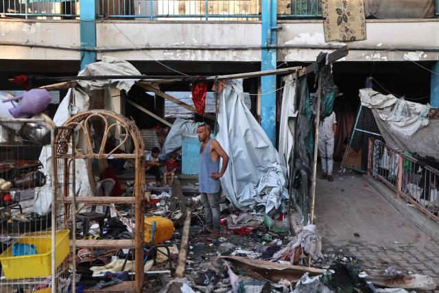 A Palestinian man reacts as he checks the damages after an Israeli strike which hit a school sheltering displaced Palestinians in the Al-Bureij camp in the central Gaza Strip on July 8, 2025. A third day of indirect negotiations on a Gaza ceasefire between Israel and Palestinian Islamist movement Hamas began in Doha on July 8, a Palestinian source close to the talks said. (Photo by Eyad BABA / AFP)