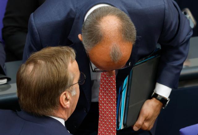 German Chancellor Friedrich Merz (R) talks with German Defence Minister Boris Pistorius during a session on the government's 2025 budget draft on July 8, 2025 at the Bundestag (lower house of parliament) in Berlin. (Photo by Odd ANDERSEN / AFP)