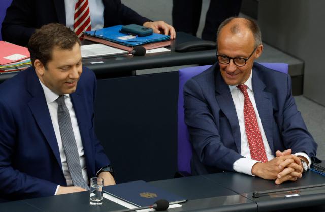 German Chancellor Friedrich Merz (R) and German Finance Minister and Vice Chancellor Lars Klingbeil sit in the government's bench during a session on the government's 2025 budget draft on July 8, 2025 at the Bundestag (lower house of parliament) in Berlin. (Photo by Odd ANDERSEN / AFP)