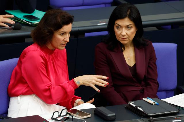 German Minister for Research, Technology and Aerospace Dorothee Baer (L) and German Economy and Energy Minister Katherina Reiche chat during a session on the government's 2025 budget draft on July 8, 2025 at the Bundestag (lower house of parliament) in Berlin. (Photo by Odd ANDERSEN / AFP)