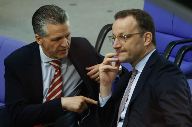 Chief of Staff and Minister for Special Tasks Thorsten Frei (L) and the Parliamentary group leader of Germany's Christian Democratic Union (CDU) and former Health Minister Jens Spahn confer during a session on the government's 2025 budget draft on July 8, 2025 at the Bundestag (lower house of parliament) in Berlin. (Photo by Odd ANDERSEN / AFP)