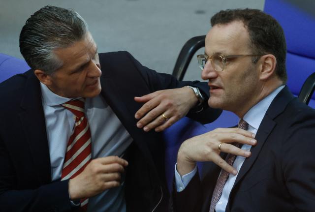 Chief of Staff and Minister for Special Tasks Thorsten Frei (L) and the Parliamentary group leader of Germany's Christian Democratic Union (CDU) and former Health Minister Jens Spahn confer during a session on the government's 2025 budget draft on July 8, 2025 at the Bundestag (lower house of parliament) in Berlin. (Photo by Odd ANDERSEN / AFP)