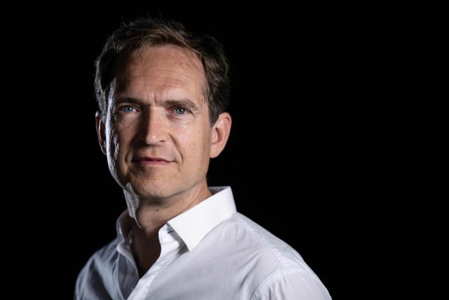 French author Fabrice Humbert poses during a photo session in Paris on July 7, 2025. (Photo by JULIEN DE ROSA / AFP)