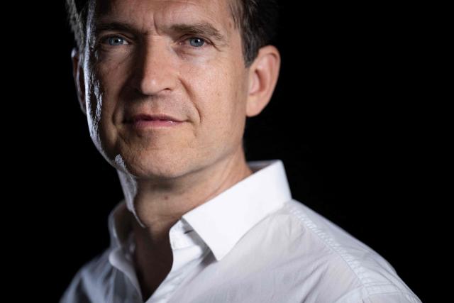 French author Fabrice Humbert poses during a photo session in Paris on July 7, 2025. (Photo by JULIEN DE ROSA / AFP)