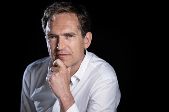French author Fabrice Humbert poses during a photo session in Paris on July 7, 2025. (Photo by JULIEN DE ROSA / AFP)