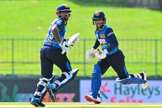 Sri Lanka's Pathum Nissanka (R) and Kusal Mendis run between the wickets during the third and final one-day international (ODI) cricket match between Sri Lanka and Bangladesh at the Pallekele International Cricket Stadium in Kandy on July 8, 2025. (Photo by Ishara S. KODIKARA / AFP)