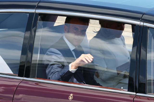 France's President Emmanuel Macron and his wife Brigitte Macron leave by car after their arrival at RAF Northolt, west of London, on July 8, 2025, on the first day of a three-day state visit to Britain. French President Emmanuel Macron began a three-day state visit to Britain on Tuesday, which will see him address parliament and try to rekindle a purportedly warm relationship with King Charles III. (Photo by Gonzalo Fuentes / POOL / AFP)