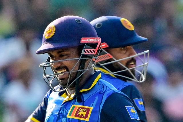 Sri Lanka's captain Charith Asalanka (L) and Kusal Mendis run between the wickets during the third and final one-day international (ODI) cricket match between Sri Lanka and Bangladesh at the Pallekele International Cricket Stadium in Kandy on July 8, 2025. (Photo by Ishara S. KODIKARA / AFP)