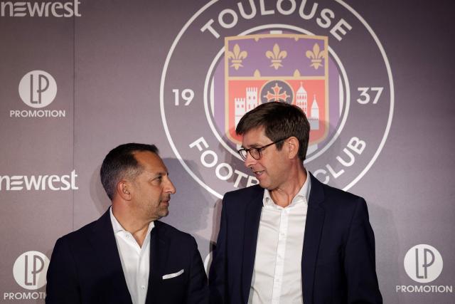 New Toulouse Football Club (TFC) President Olivier Cloarec (R) and Managing Director of RedBird Capital Partners and Interim Chairman of TFC Neil Chugani (L) look each other  after giving a press conference at the Stadium de Toulouse, in Toulouse, south-western France, on July 8, 2025. (Photo by Valentine CHAPUIS / AFP)
