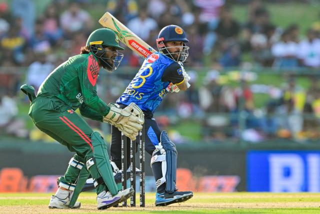 Sri Lanka's Kusal Mendis (R) plays a shot during the third and final one-day international (ODI) cricket match between Sri Lanka and Bangladesh at the Pallekele International Cricket Stadium in Kandy on July 8, 2025. (Photo by Ishara S. KODIKARA / AFP)