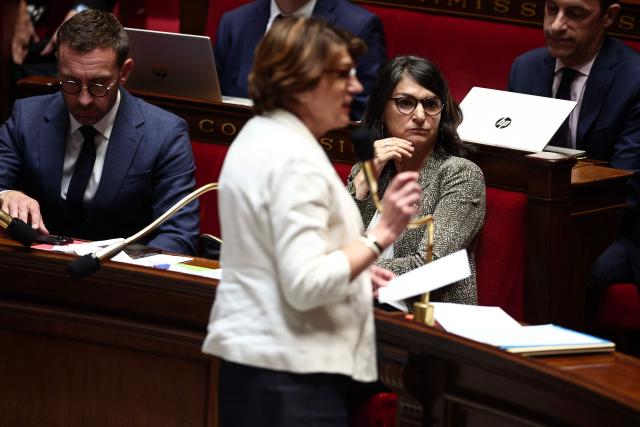 French left wing MP Aurelie Trouve (R) listens as France's Minister for Agriculture and Food Sovereignty Annie Genevard (C) speaks during a debate at the National Assembly before a vote on the 'Duplomb law' on agriculture which aims to reintroduce a pesticide for certain crops, in Paris on July 8, 2025. (Photo by Guillaume BAPTISTE / AFP)