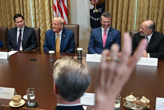 US President Donald Trump (2L) looks on as a reporter raises their hand to ask a question during a cabinet meeting in the Cabinet Room of the White House in Washington, DC, on July 8, 2025. Also pictured, L/R, Secretary of State Marco Rubio, Secretary of Defense Pete Hegseth, and Secretary of Commerce Howard Lutnick. (Photo by ANDREW CABALLERO-REYNOLDS / AFP)